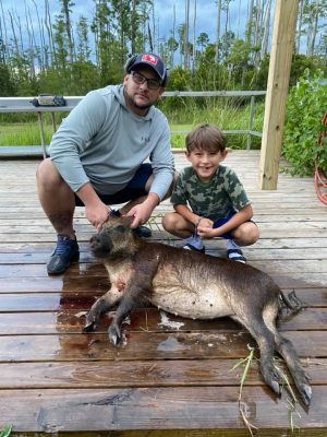 Coy and his son with a nice meat hog!! The rain had them moving yesterday!